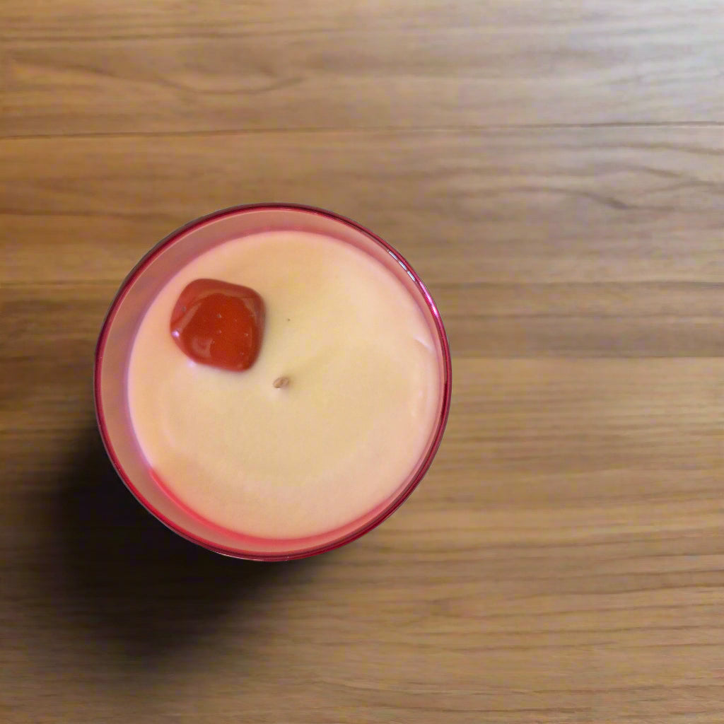 Candle with a red wick on a wooden surface